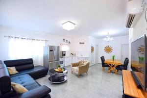 a living room with a couch and a table at אגם בגליל - וילה ו-3 סוויטות עם בריכה מחוממת בעבדון in Wadi Keren