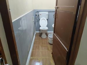 a bathroom with a toilet with the lid up at Swamy Residency in Vellore