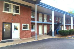 a brick building with a staircase in a parking lot at Capital O Elite Inn & Suites South Holland I 94 in South Holland
