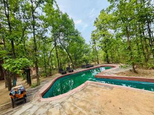 an overhead view of a swimming pool with trees at Emerald Tiger Retreat in Tāla