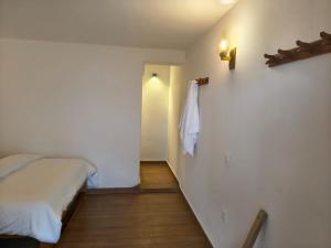 a small bedroom with a bed and a hallway at RJ Boutique Hotel - Ghandruk in Astam