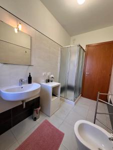 a white bathroom with a sink and a shower at Appartamenti Portavenezia in Padova +45 photos