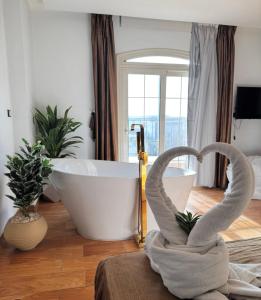 a bathroom with a bath tub and a bath towel at Palm Pyramids View Hotel in Cairo