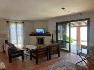 a living room with a couch and a fireplace at Seu Lar em Imbè in Imbé