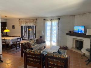 a living room with a couch and a fireplace at Seu Lar em Imbè in Imbé
