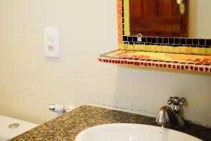 a bathroom with a sink and a mirror at Barra Quintal - Studio 2 in Barra Grande