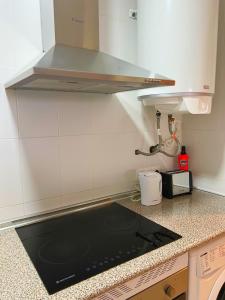 a kitchen with a sink and a stove top oven at Loma Blanca by Residea in Manilva