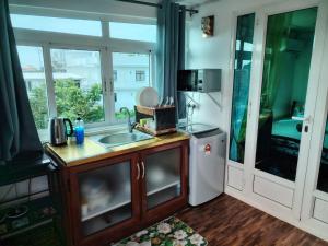 a kitchen with a sink and a window at Villa Camille A8A in Grand-Baie
