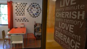a room with a table and a sign that saysive every minute differently every memory at Ringo's Foyer in Melaka