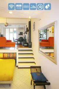 サヴォーナにあるBali Loft Savona Albissolaのリビングルーム(オレンジの椅子、鏡付)