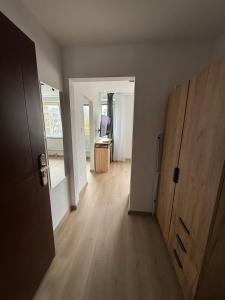 an empty room with a hallway with a wooden door at Ďumbierska Sásová Apartment in Otilia