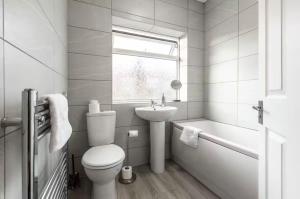 a white bathroom with a toilet and a sink at Connaught Stays - Home from Home in Preston +14 photos