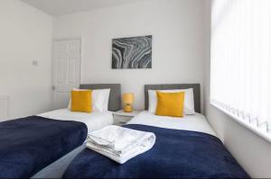 two beds sitting next to each other in a room at Connaught Stays - Home from Home in Preston