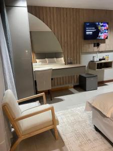 a living room with a bed and a tv at The Legacy Hotel and Spa in Tzaneen