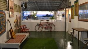 a room with a bike on the wall and a table at Ringo's Foyer in Melaka