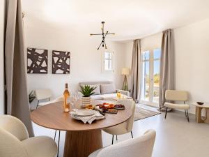 a living room with a table and a couch at Sanders Paros Gardens in Molos Parou