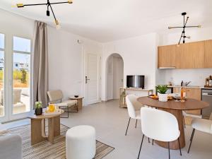 a kitchen and living room with a table and chairs at Sanders Paros Gardens in Molos Parou +12 photos