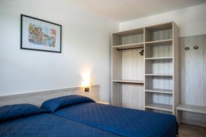 Giường trong phòng chung tại Villaggio Ducale