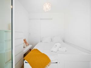 a white bedroom with a bed and a mirror at Le Cocon - 5 min to Monaco - Ideal couple or business - Free private parking - Near events - Terrace and balcony - Premium services in Fontvieille