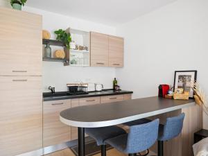 a kitchen with a table and two chairs at Le Cocon - 5 min to Monaco - Ideal couple or business - Free private parking - Near events - Terrace and balcony - Premium services in Fontvieille