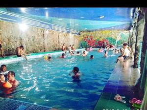 a group of people in a swimming pool at Гостевой дом Алтын Булун - Golden Bay на Иссык-Куле in Chok-Tal