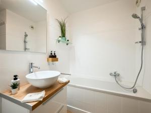 a bathroom with a sink and a bathtub and a sink at Le Cocon - 5 min to Monaco - Ideal couple or business - Free private parking - Near events - Terrace and balcony - Premium services in Fontvieille