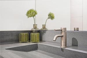 a kitchen sink with two vases with plants in them at Seaside Panorama Villa 6p - Direct aan de Baai - Villa 37 in Ouddorp +84 photos