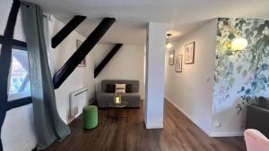 a living room with a couch and a chair at Le Printemps 