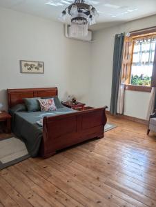 a bedroom with a bed and a wooden floor at 3HOUSE Sol na Eira em Paredes in Rebordosa +49 photos