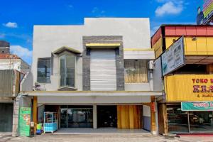 a group of buildings on a street at Hotel O Near Tugu Yogyakarta 1 formerly Crown Residence in Jetis