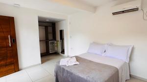 a bedroom with a bed with a towel on top of it at Pousada Cahê in Ilhabela +17 photos