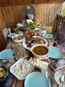 a table topped with lots of different dishes of food at Niko Mamasakhlisi Guest House in Ozurgetʼi