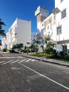 an empty street in a city with tall buildings at Buxton Point Furnished Apartment in Mombasa