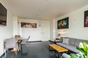een woonkamer met een bank en een tafel bij Kapselhotel nähe Hauptbahnhof Halle-Saale in Halle an der Saale