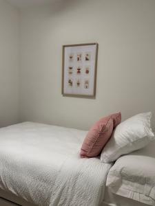 a bed with two pillows and a picture on the wall at Calma Mediterránea in Aguadulce +26 photos