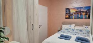 a bedroom with a bed with blue pillows on it at Apartman Blue in Subotica