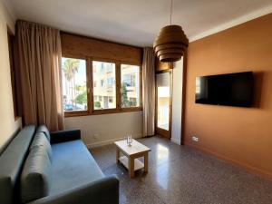 a living room with a couch and a tv and a table at Immeuble du Mausolée in Rabat