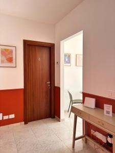 an office with a wooden door and a desk at Be Your Home - Cruise Stop Guest House in Civitavecchia +18 photos