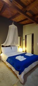 a bedroom with a large bed with a blue blanket at Stone View Nest - By Ski Alure in Arachova