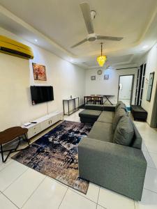 a living room with a couch and a flat screen tv at Az homes AG in Kampong Jelatang +7 photos