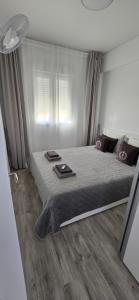 a bedroom with a large bed with two mats on it at Apartamentos playa Romanilla in Roquetas de Mar