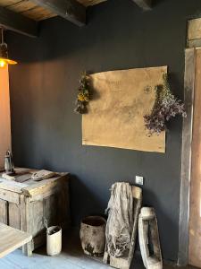 a wall with a painting and some flowers on it at A North Homestay in Omalo +13 photos