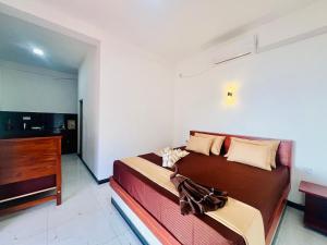 Un dormitorio con una cama grande y una cómoda. en Blue Surf View - Tangalle, en Tangalle