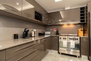 a kitchen with stainless steel cabinets and a stove at Sunny Side I Free heated pool in Tábua