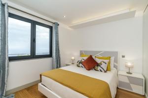 a bedroom with a bed and a large window at Sunny Side I Free heated pool in Tábua +33 photos