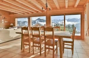 a dining room with a wooden table and chairs at Chalet Les Sonnailles du Mont in Le Grand-Bornand