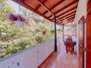 a porch with plants on the side of a house at Linu Villa in Hikkaduwa +18 photos