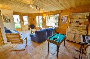 a living room with a blue couch and a table at Chalet Les Sonnailles du Mont in Le Grand-Bornand +17 photos