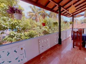 a balcony with plants and birds on the wall at Linu Villa in Hikkaduwa