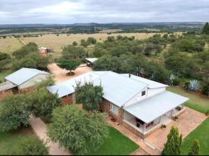 an overhead view of a house with a white roof at Buck Hill Bush Lodge in Maanhaarrand